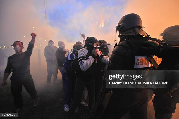 Protesting prison guards blocking the entrance of the Fleury-Merogis prison, a Paris suburb, argue with French anti-riot police who used tear gas to...