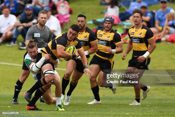 Kane Koteka of the Spirit looks to pass the ball while being tackled by Tom Connor of the Rays during the round eight NRC match between Perth and the...
