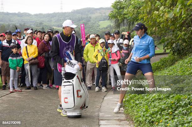 Carlota Ciganda of Spain retrieves the ball from bushes next to a cart path on the 4th hole during day three of the Swinging Skirts LPGA Taiwan...