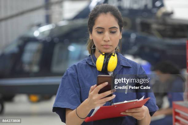 young female engineer working with helicopters - indian pilot stock-fotos und bilder