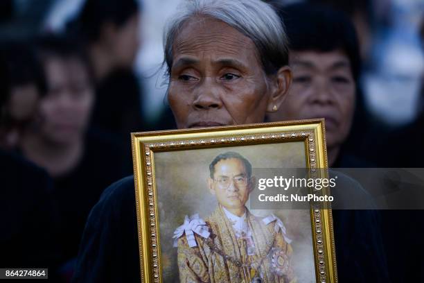 Thai mourner holds a portrait of the late Thai King Bhumibol Adulyadej in the area of the Grand Palace in Bangkok, Thailand, 21 October 2017.