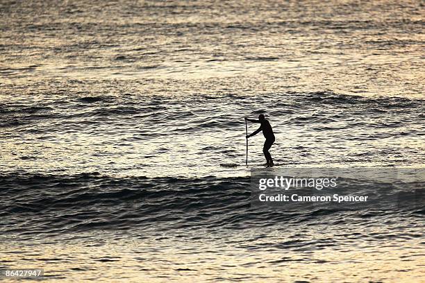 Paul Hawkins paddles towards a set of waves on his stand-up paddleboard at Queenscliff Beach on May 1, 2009 in Sydney, Australia. Modern Stand-up...