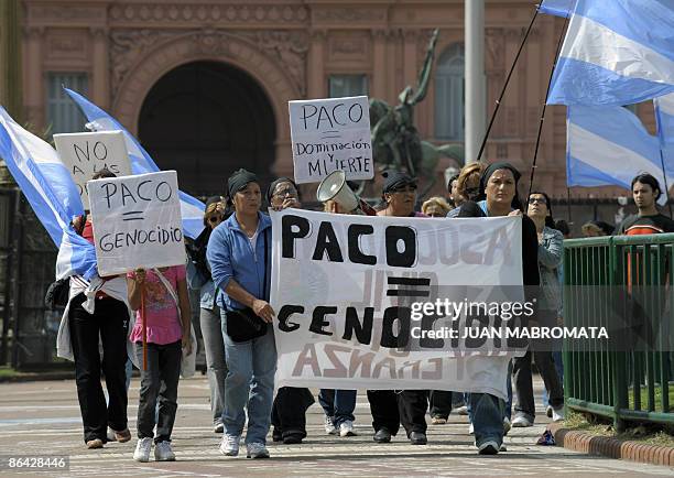Womens and relatives of those addicted to 'paco' --PBC, cocacine base paste-- march holding a banner reading "PACO = Genocide" during a demonstration...