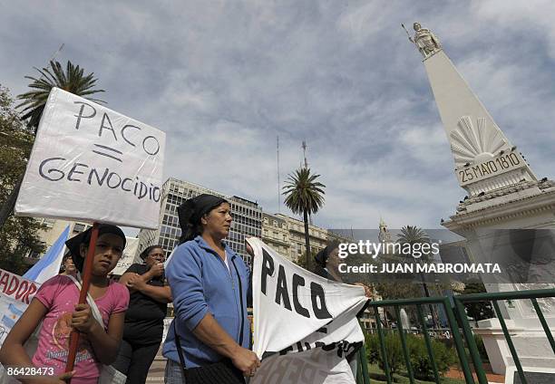 Women and relatives of those addicted to 'paco' --PBC, cocacine base paste-- march holding a banner reading "PACO = Genocide" during a demonstration...