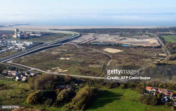 This aerial view taken on October 14, 2017 shows the site of the former "Jungle" migrant camp that was evacuated 12 months ago in Calais, and the...