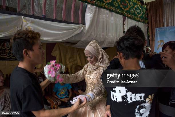 Bride Katty Malang Mikunug , dances with family and friends on October 21, 2017 in Saguiaran in Lanao del Sur, southern Philippines. Paulo, a...