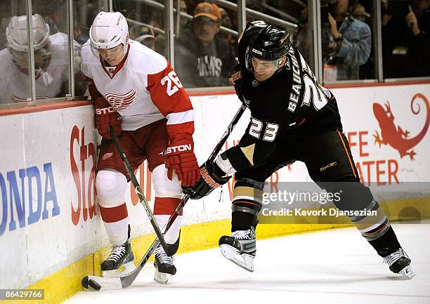 Jiri Hudler of the Detroit Red Wings battles Francois Beauchemin of the Anaheim Ducks for possession of the puck during Game Three of the Western...