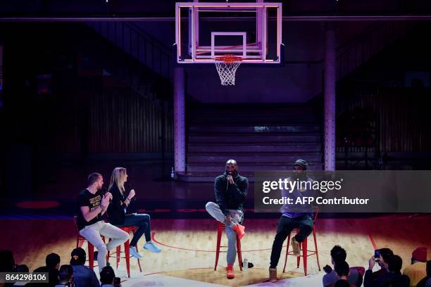 Former NBA basketball player Kobe Bryant speaks as former FRench power forward Ronny Turiaf looks on, during a promotional event organized by the...