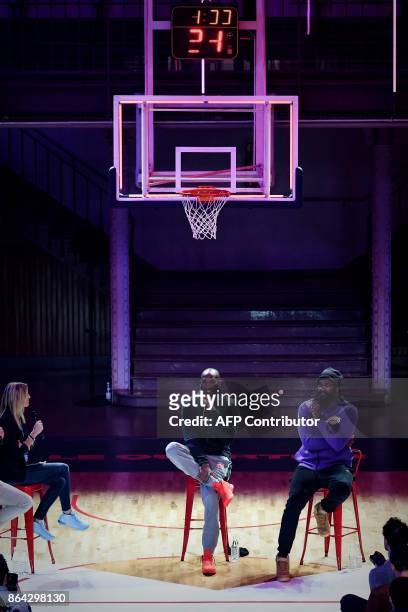 Former NBA basketball player Kobe Bryant speaks as former French power forward Ronny Turiaf looks on, during a promotional event organized by the...