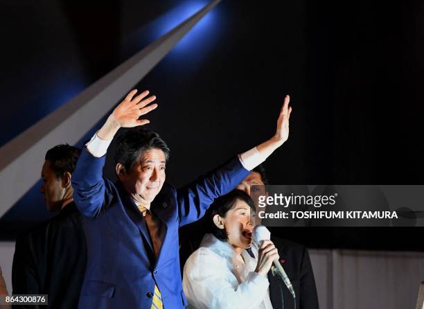 Japan's Prime Minister and ruling Liberal Democratic Party leader Shinzo Abe waves to supporters during his last stumping tour for the October 22...