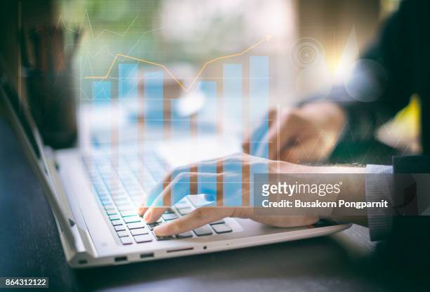 business documents on office digital computer laptop and graph financial with social network diagram and man working in the - financing stock-fotos und bilder