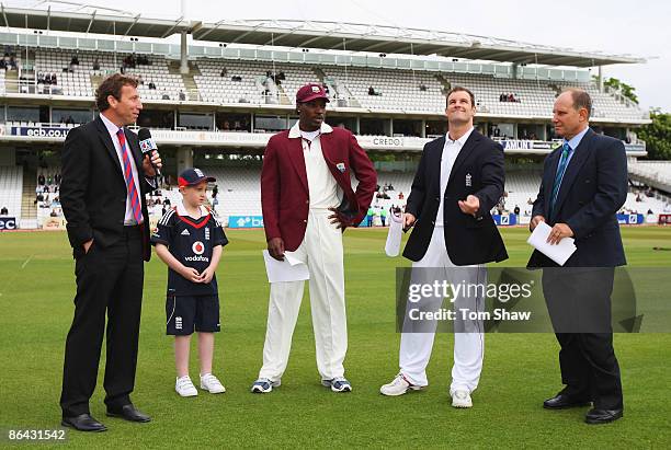 England captain Andrew Strauss tosses the coin watched by West Indies captain Chris Gayle, match referee Andy Pycroft and commentator Michael...
