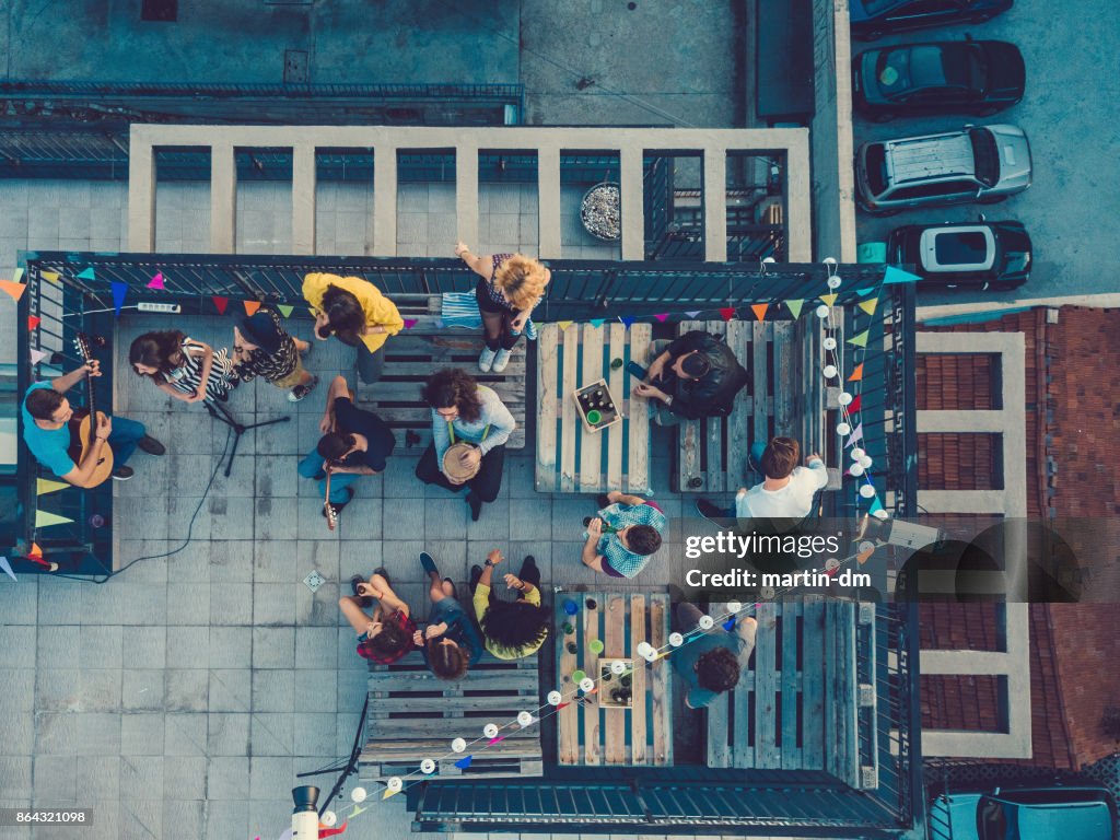 Friends listening to a music band on the rooftop