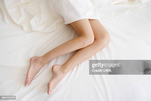 close up of  sleeping woman's legs  - adult woman legs close up stock-fotos und bilder