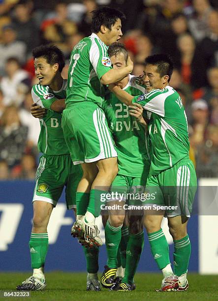 Ryan Griffiths of Guoan is congratulated by team mates after scoring a goal during the AFC Champions League Group match between the Newcastle Jets...