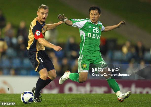 Jobe Wheelhouse of the Jets contests the ball with Guo Hui of Guoan during the AFC Champions League Group match between the Newcastle Jets and the...