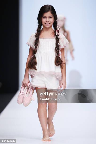 Model walks the runway at the Collective Show Alta Costura fashion show during day one of Mercedes Benz Fashion Week Russia S/S 2018 at Manege on...