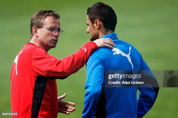 Head coach Ralf Rangnick talks to Sejad Salihovic during a training session of 1899 Hoffenheim at the club's training center on May 6, 2009 in...