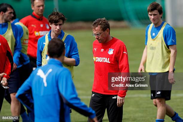 Head coach Ralf Rangnick is surrounded by his players during a training session of 1899 Hoffenheim at the club's training center on May 6, 2009 in...