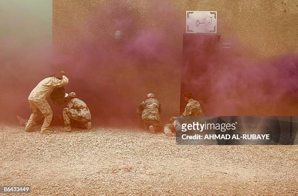 Iraqi military rescue officers are put through their paces during a training session on emergency rescue at the old Muthana airport in Baghdad on May...