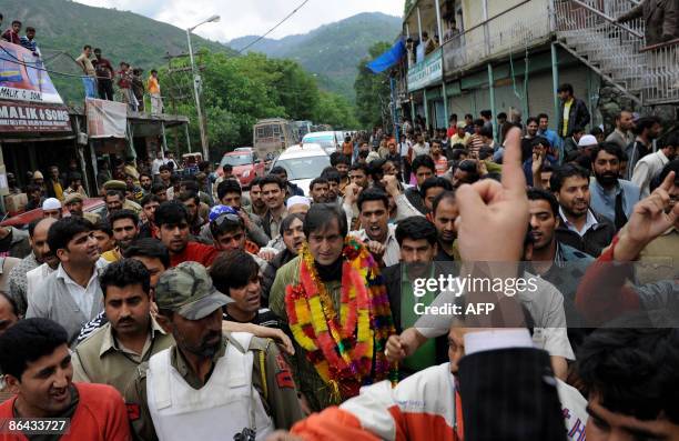 Chairman of the Jammu and Kashmir People's Conference Sajad Gani Lone a candidate for India's general elections, walks during an election campaign...