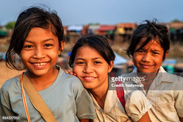happy cambodian schoolgirls near tonle sap, cambodia - cambodia stock pictures, royalty-free photos & images