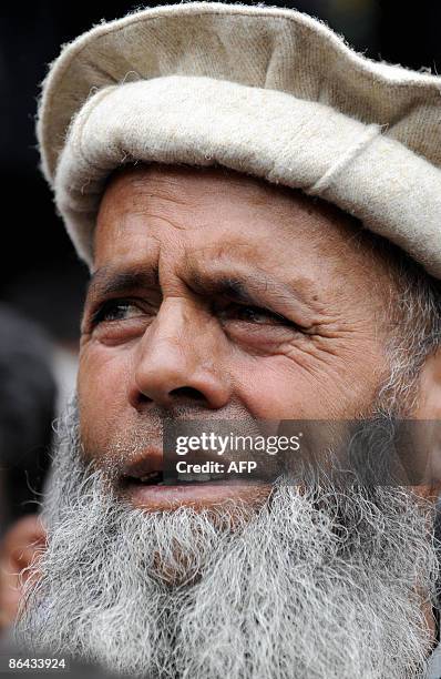 An Kashmiri man listens to a speech by chairman of the Jammu and Kashmir People's Conference Sajad Gani Lone, a candidate for India's general...