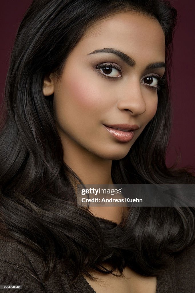 Woman with long shiny dark hair, portrait.