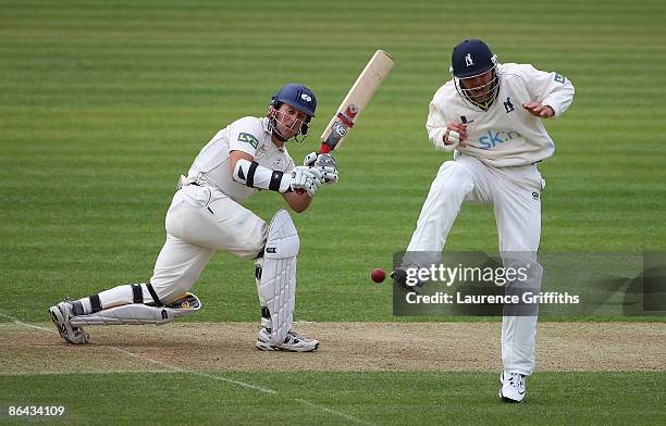 Joe Sayers of Yorkshire hits out as Jonathan Trott of Warwickshire takes evasive action during the LV County Championship Division One match between...