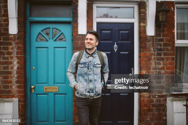 young man going out to work from home - going out of business expressão inglesa imagens e fotografias de stock