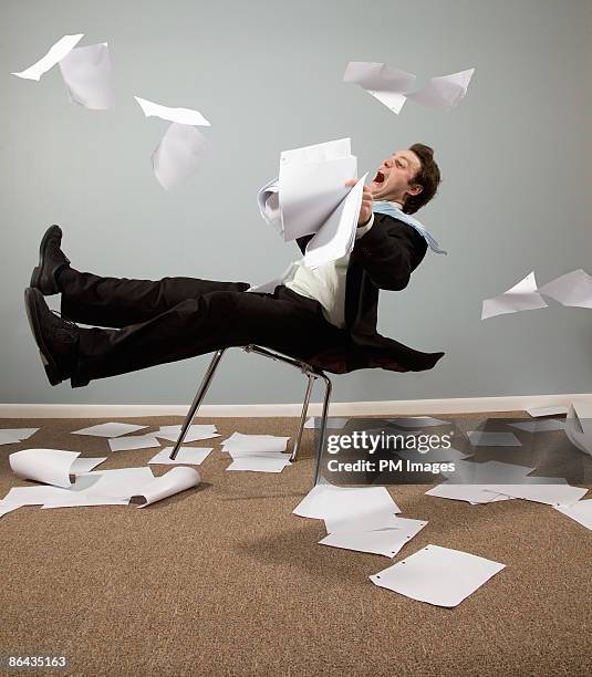 businessman caught in wind - chaos büro stock pictures, royalty-free photos & images