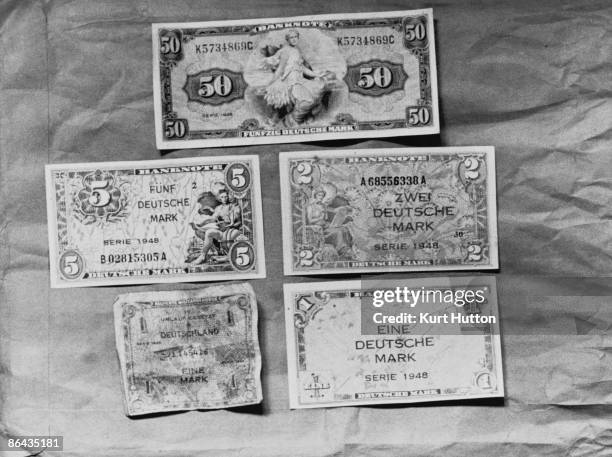 Newly-issued Deutsche Mark notes, which are replacing the old Reichsmark and Rentenmark in West Germany, June 1948. The note at bottom left is...