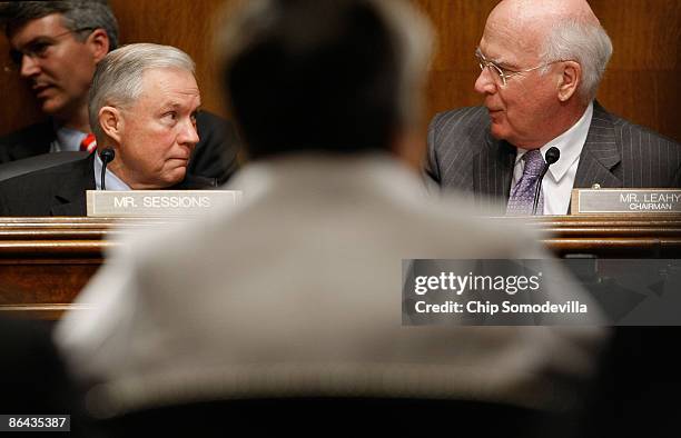 Senate Judiciary Committee Chairman Patrick Leahy talks with the newly-appointed committee ranking member Sen. Jeff Sessions while hearing testimony...