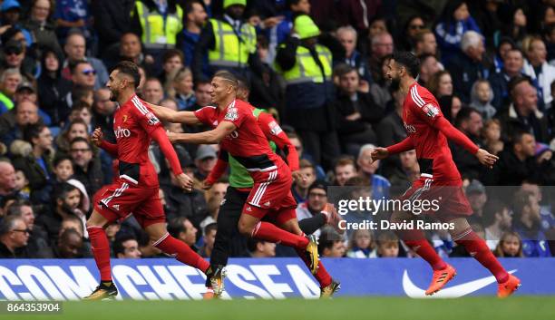 Roberto Pereyra celebrates scoring his side's second goal with Richarlison de Andrade of Watford and Miguel Britos of Watford during the Premier...