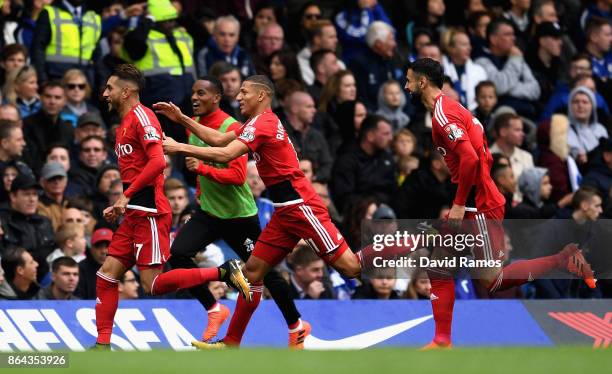 Roberto Pereyra celebrates scoring his side's second goal with Richarlison de Andrade of Watford and Miguel Britos of Watford during the Premier...