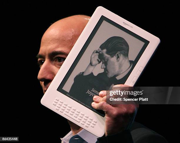 Amazon CEO Jeff Bezos holds the new Kindle DX, which he unveiled at a press conference at the Michael Schimmel Center for the Arts at Pace University...