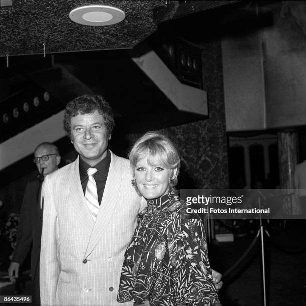 British singer Petula Clark and her husband, French music agent Claude Wolff pose together in the lobby of the International Hotel at the opening of...