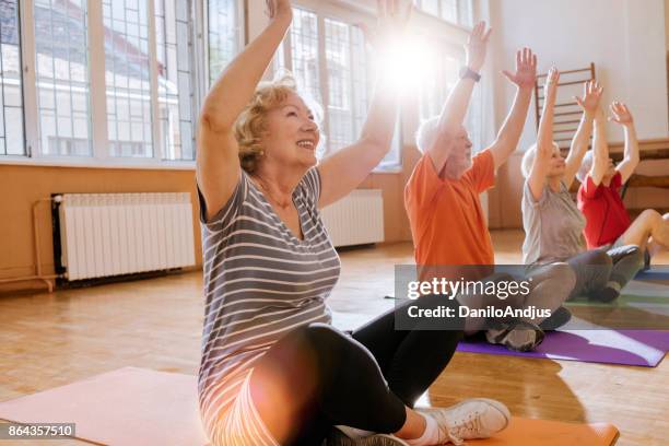 active seniors enjoying retirement - yoga stock pictures, royalty-free photos & images