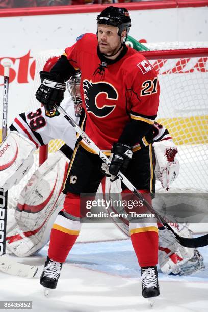 Olli Jokinen of the Calgary Flames skates in front of Nikolai Khabibulin of the Chicago Blackhawks during Game Six of the Western Conference...