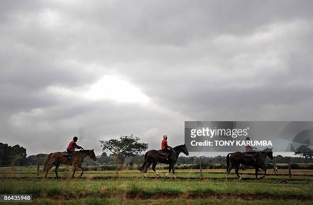 This photo taken on April 7, 2009 shows Kenyan horse trainers preparing during a morning workout at the Ngong race-course in Nairobi. Started in 1904...