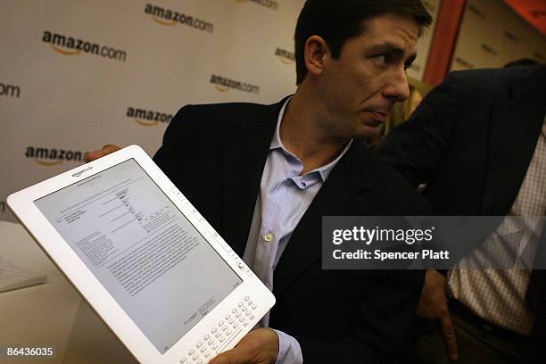 Members of the media are given a demonstration of the new Kindle DX, which he unveiled at a press conference by Amazon CEO Jeff Bezos at the Michael...