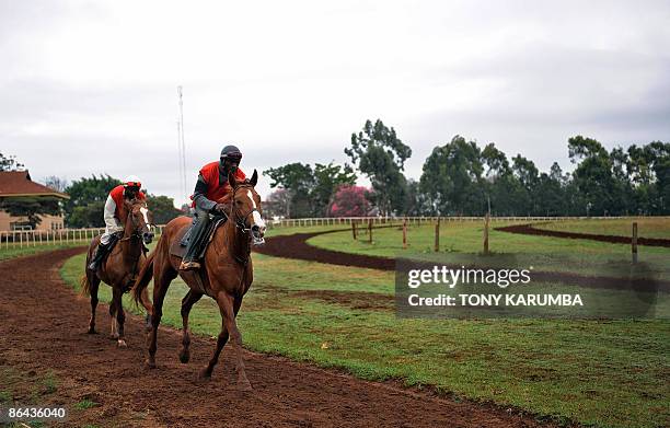 This photo taken on April 7, 2009 shows jockeys and their horses on a morning workout at the Ngong race-course in Nairobi. Started in 1904 in Kenya...