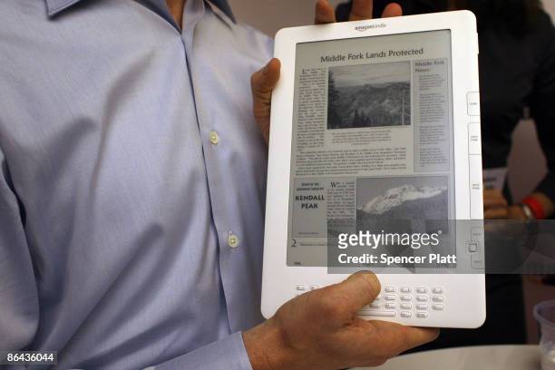 Members of the media are given a demonstration of the new Kindle DX, which he unveiled at a press conference by Amazon CEO Jeff Bezos at the Michael...
