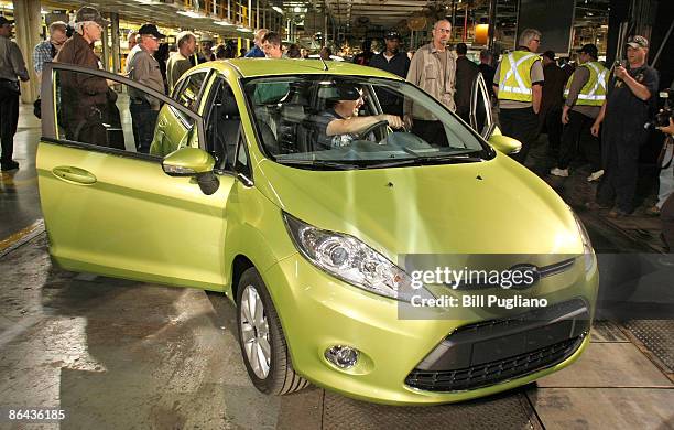 Auto workers examine a new Ford Fiesta at the new Ford Michigan Assembly Plant May 6, 2009 in Wayne, Michigan. Ford announced they are investing $550...