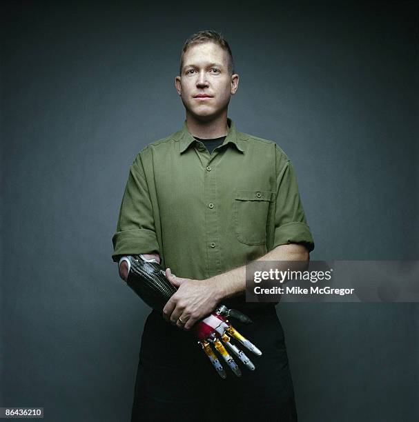 Marine Captain and Iraqi Vet, Jonathan Kuniholm poses at a portrait session for IEEE Spectrum Magazine wearing a prototype of a neurally controlled...