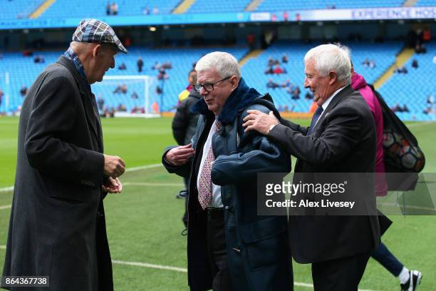 Commentator John Motson is presented with a coat by Manchester City life president Bernard Halford and former player Mike Summerbee prior to the...