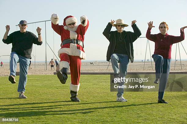 santa claus in tai chi class on beach - tai chi shadow stock pictures, royalty-free photos & images