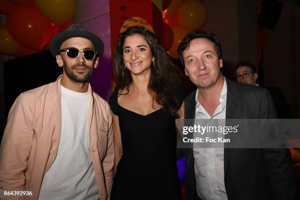 Photographer JR, Lorraine Ricard and Emmanuel Perrotin attend the 'Bal Jaune Elastique 2017' : Dinner Party at Palais Brongniart on October 20, 2017...