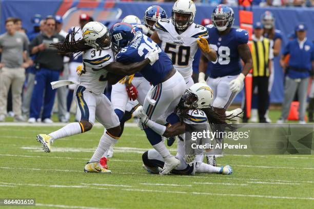 Safeties Jahleel Addae and Tre Boston of the Los Angeles Chargers make a stop in action against the New York Giants during an NFL game at MetLife...