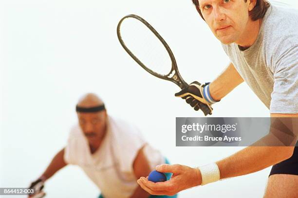 racquetball, man in front ready to serve - racketball stock pictures, royalty-free photos & images